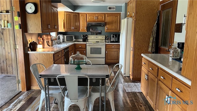 kitchen featuring dark hardwood / wood-style flooring, white appliances, sink, exhaust hood, and a center island