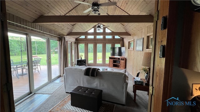 living room featuring ceiling fan, wood ceiling, lofted ceiling with beams, and a wealth of natural light