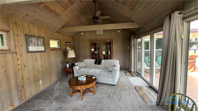 exterior space featuring ceiling fan, wood-type flooring, wooden ceiling, and wooden walls