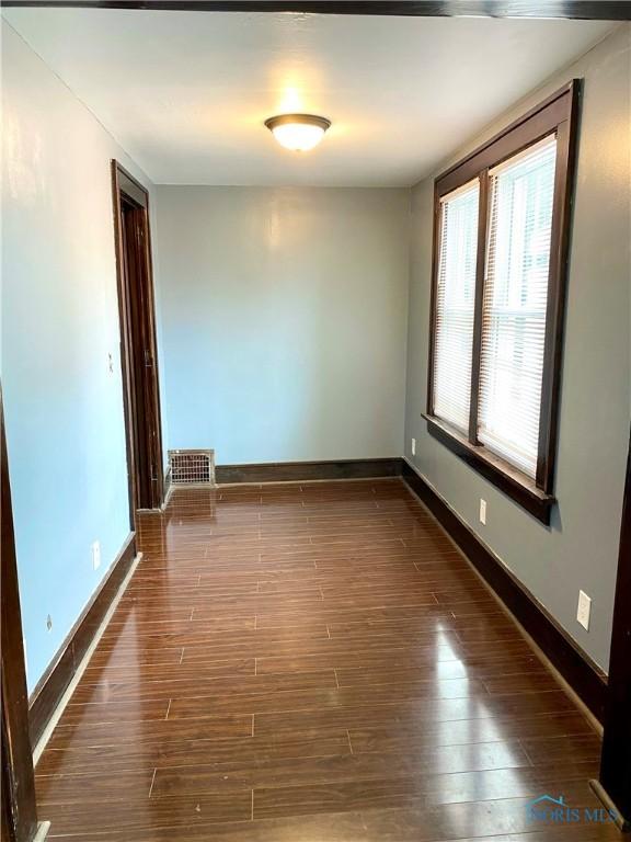 spare room featuring dark hardwood / wood-style flooring