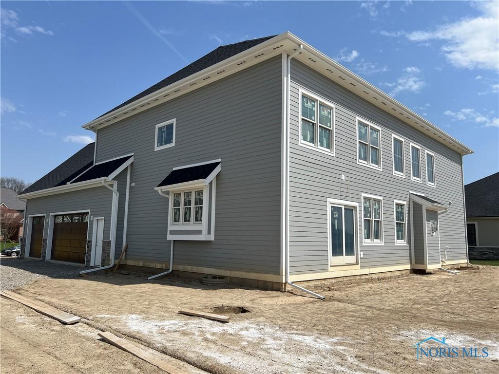 3688 Turtle Creek Dr, Perrysburg, OH 43551 - view of home's exterior with an attached garage and gravel driveway