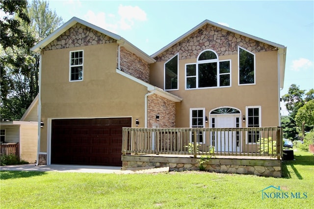 view of front of property with a garage and a front lawn