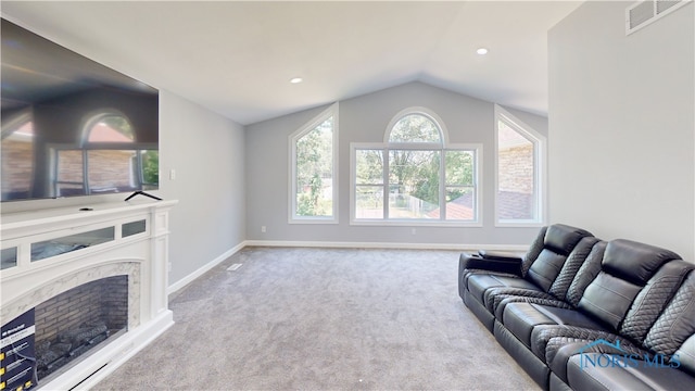 carpeted living room featuring a fireplace and lofted ceiling