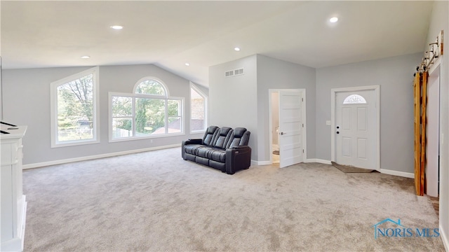 carpeted entryway with lofted ceiling