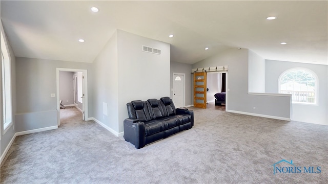 living area featuring carpet floors and lofted ceiling