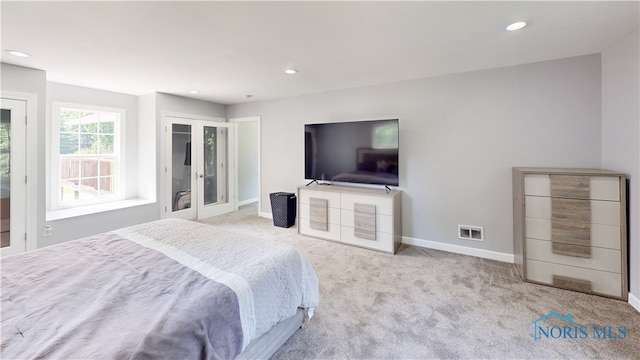 carpeted bedroom with french doors