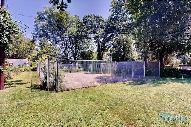 view of yard with basketball hoop