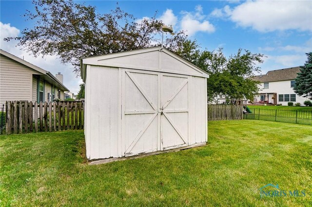 view of outdoor structure featuring a lawn