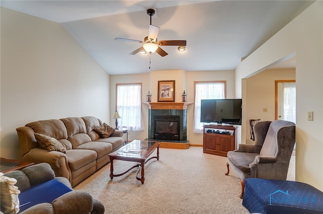 living room with carpet, a tile fireplace, a wealth of natural light, and ceiling fan