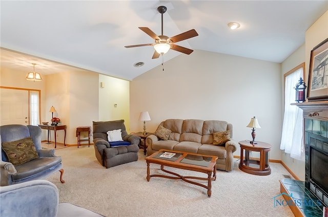 carpeted living room featuring vaulted ceiling, a fireplace, and plenty of natural light