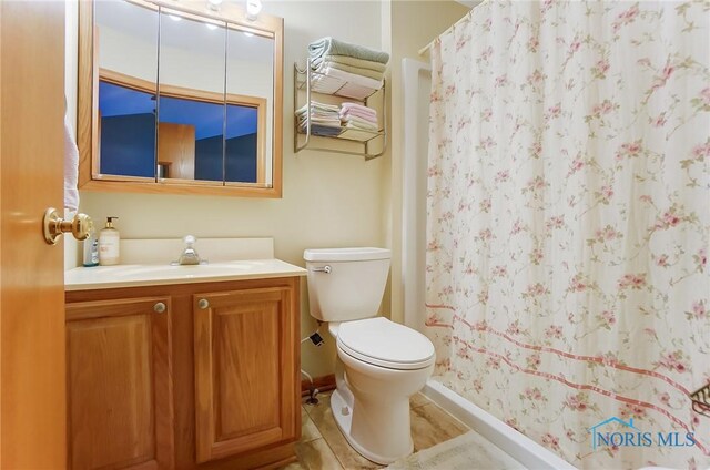 bathroom with vanity, toilet, and tile patterned floors