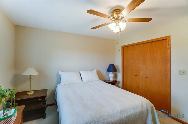 carpeted bedroom featuring a closet and ceiling fan