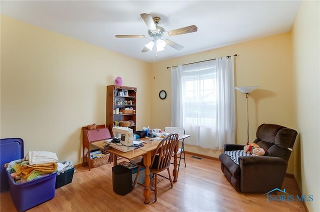 office space featuring wood-type flooring and ceiling fan