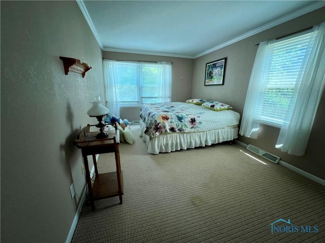 carpeted bedroom featuring multiple windows and ornamental molding