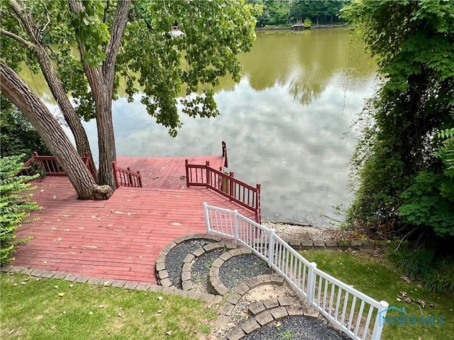 wooden terrace featuring a water view