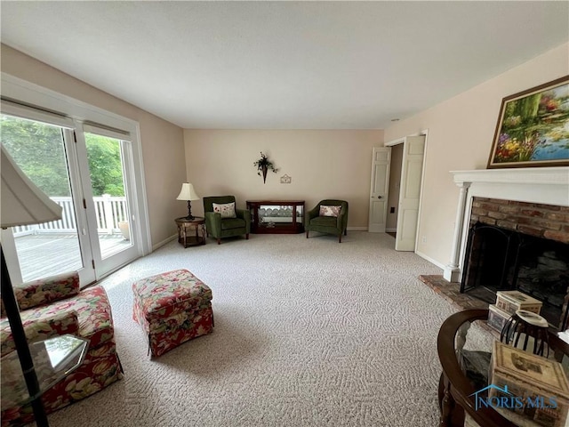 sitting room with carpet flooring and a fireplace