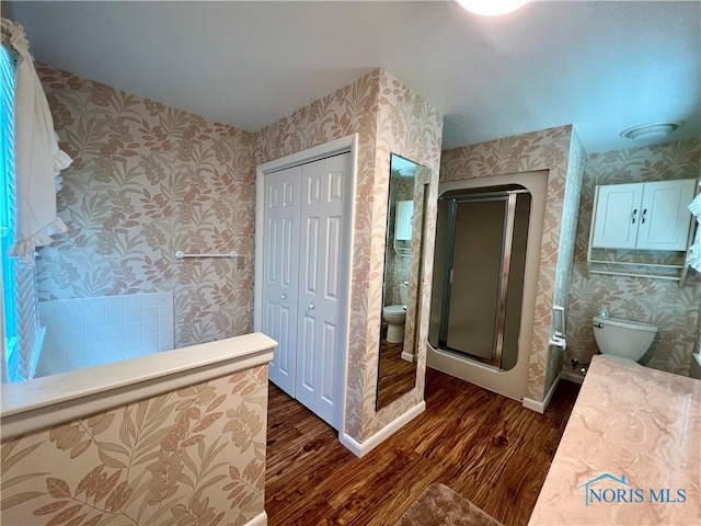 bathroom featuring walk in shower, a bidet, wood-type flooring, and toilet