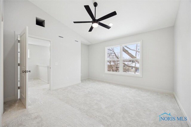 unfurnished bedroom featuring lofted ceiling, light colored carpet, and ceiling fan