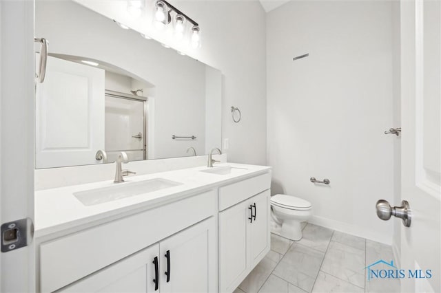 bathroom featuring walk in shower, vanity, and toilet