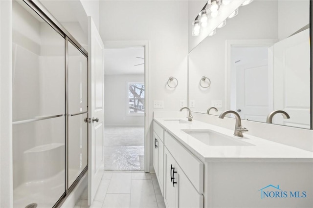 bathroom featuring vanity, tile patterned floors, and walk in shower