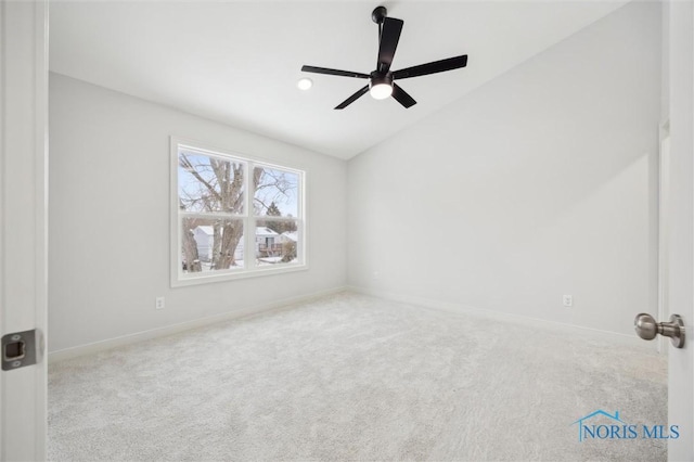 carpeted empty room featuring ceiling fan and lofted ceiling