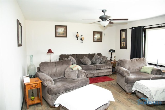 living room featuring light wood-type flooring and ceiling fan