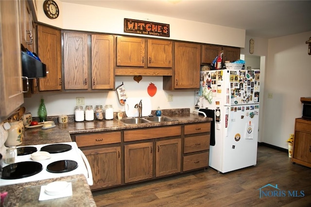 kitchen featuring white appliances, dark wood-type flooring, range hood, and sink