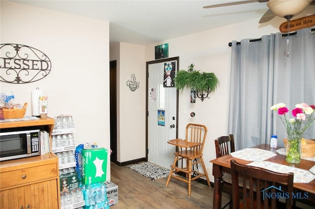 dining room featuring ceiling fan and dark hardwood / wood-style flooring