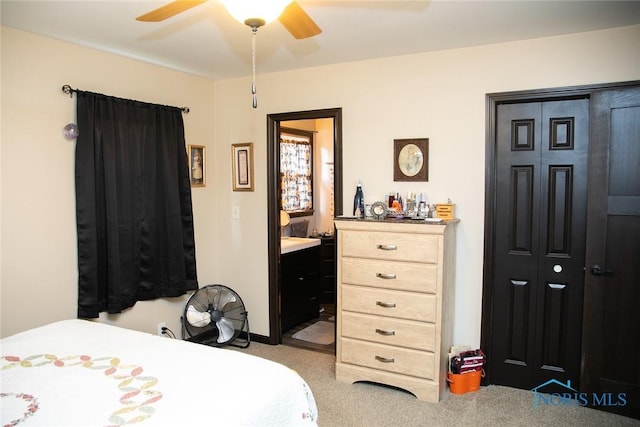 carpeted bedroom with ceiling fan and connected bathroom