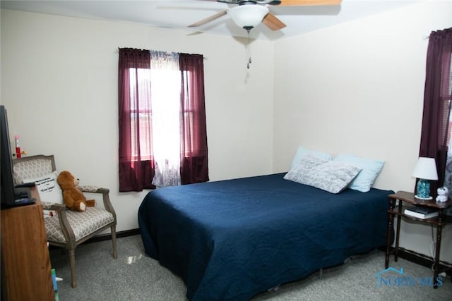 bedroom featuring ceiling fan and carpet