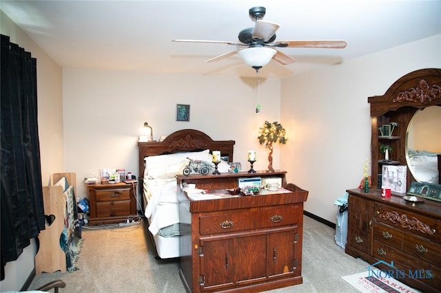 bedroom featuring light carpet and ceiling fan