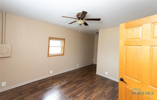 empty room with ceiling fan and dark hardwood / wood-style floors