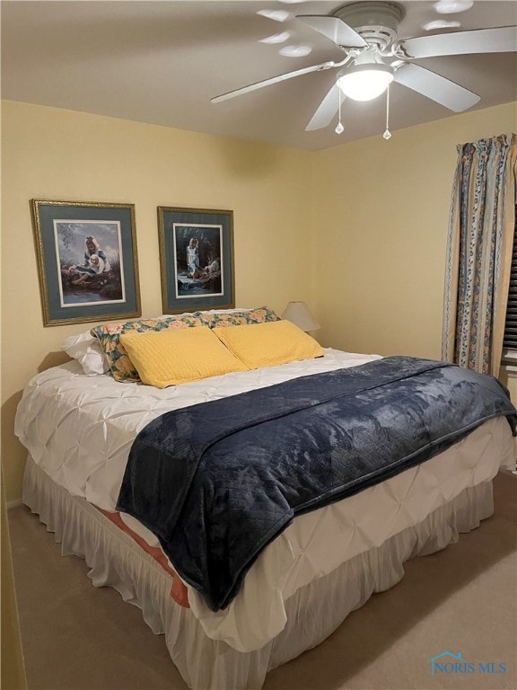 bedroom with ceiling fan and carpet floors