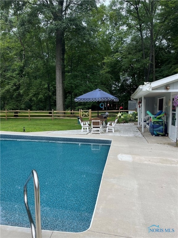 view of pool featuring a patio area and a lawn