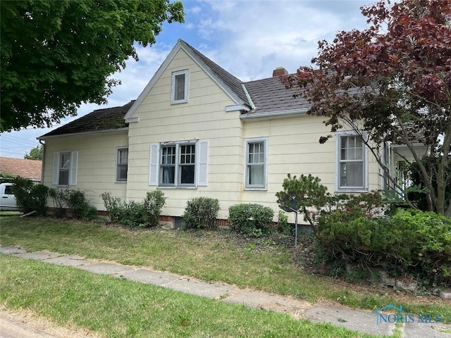 view of side of home featuring a lawn