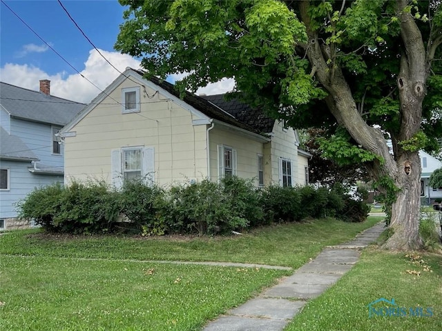 view of side of home featuring a lawn