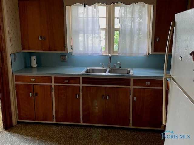 kitchen with sink and white fridge