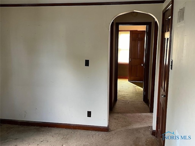 hallway featuring light colored carpet