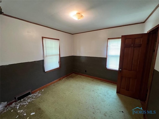 carpeted empty room with ornamental molding