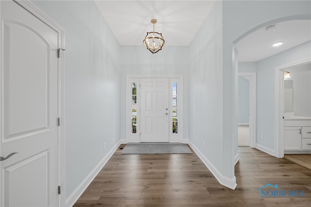 entrance foyer with a chandelier and dark hardwood / wood-style flooring