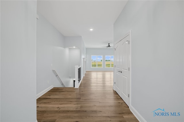 corridor with hardwood / wood-style floors