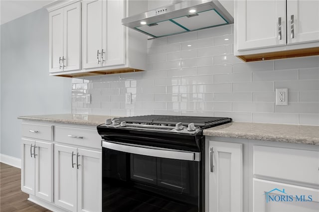 kitchen featuring black electric range, dark wood-type flooring, white cabinetry, wall chimney range hood, and decorative backsplash