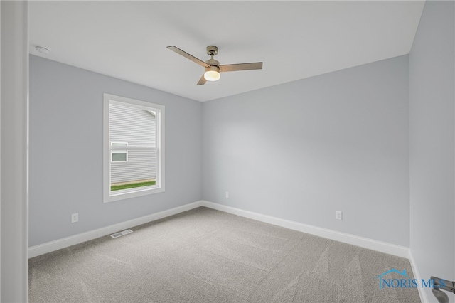 unfurnished room with ceiling fan and carpet flooring