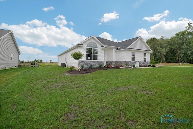 view of front of home featuring central AC and a front lawn