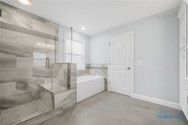 bathroom featuring independent shower and bath and tile patterned floors