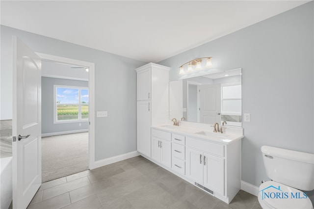 bathroom featuring tile patterned flooring, vanity, and toilet