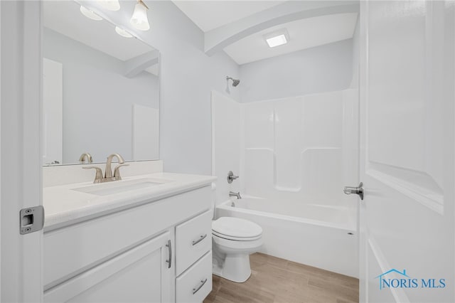 full bathroom featuring hardwood / wood-style floors, vanity, toilet, and shower / bath combination