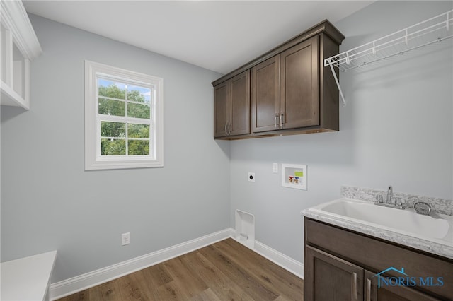 laundry area with cabinets, sink, electric dryer hookup, dark hardwood / wood-style flooring, and hookup for a washing machine