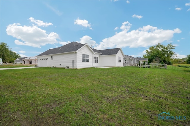 view of side of property featuring a yard and a garage