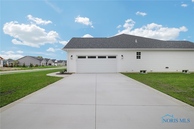 view of property exterior with a garage and a lawn